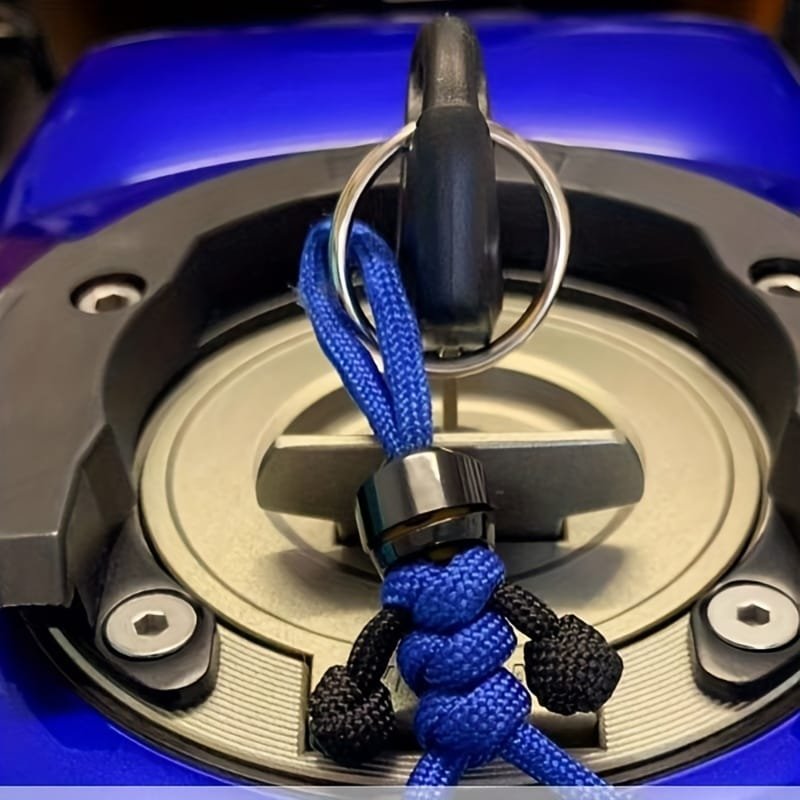 Blue and black color „Paracord“ rope pendant-man inserted into motorcycle fuel tank lock