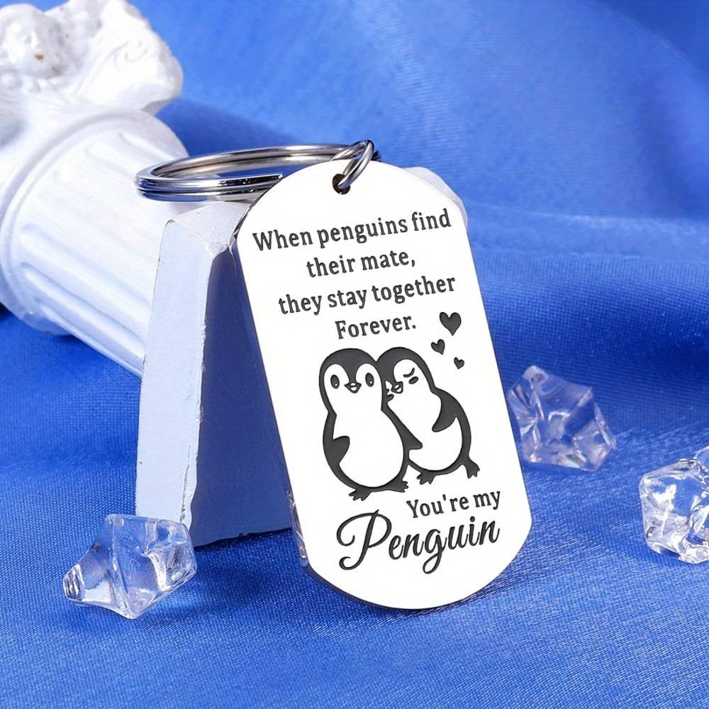 Engraved pendant with penguins and love note