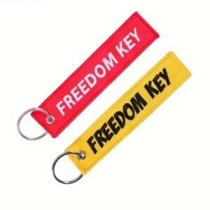 Moto keyring Freedom Key - black material with white engraving „FREEDOM KEY“.