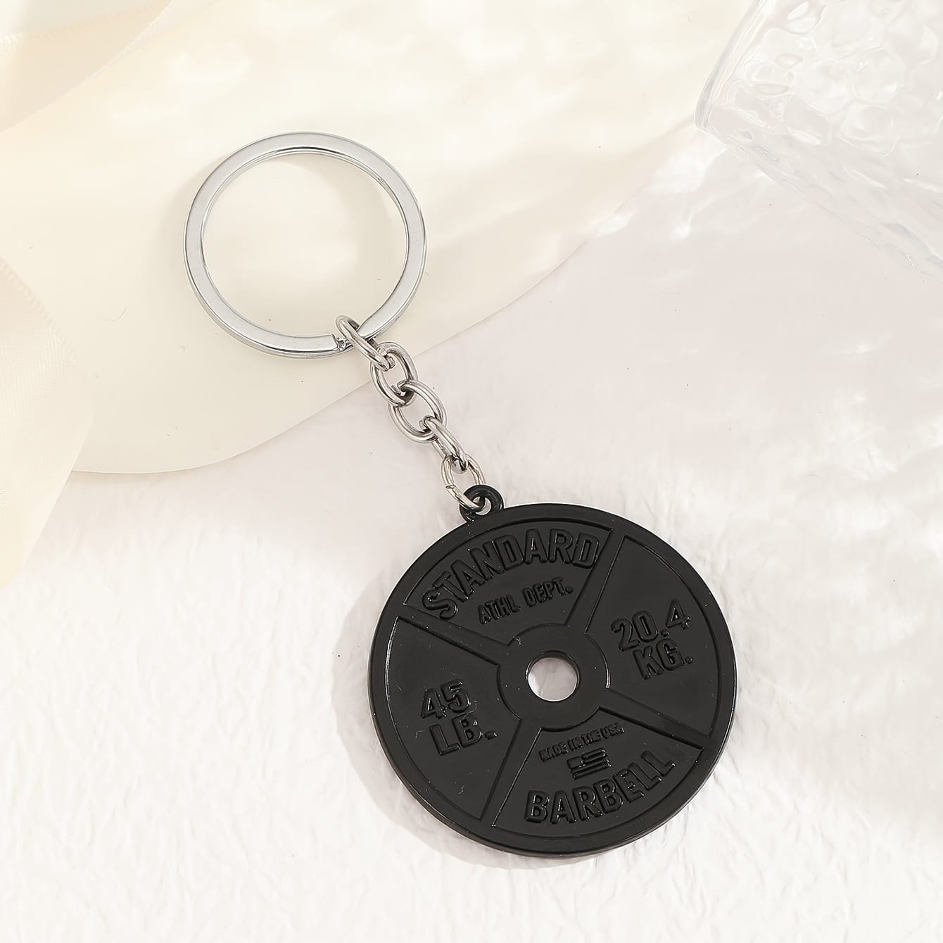 Pancake keyring - black miniature weight for gym lovers.