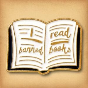 Open white book with gold lettering I read banned books enamel pin literature