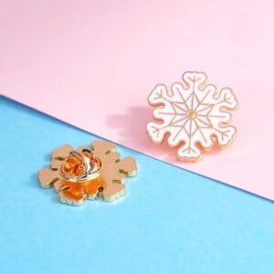 White snowflake golden outline winter accessory enamel pin pin elegant design