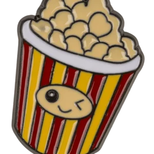 Popcorn brooch in kawaii enamel—a sparkling popcorn bucket with red and yellow stripes and a face, made of hard enamel on a dark background